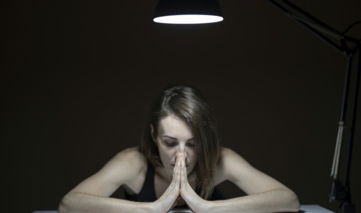 topless woman sitting on chair